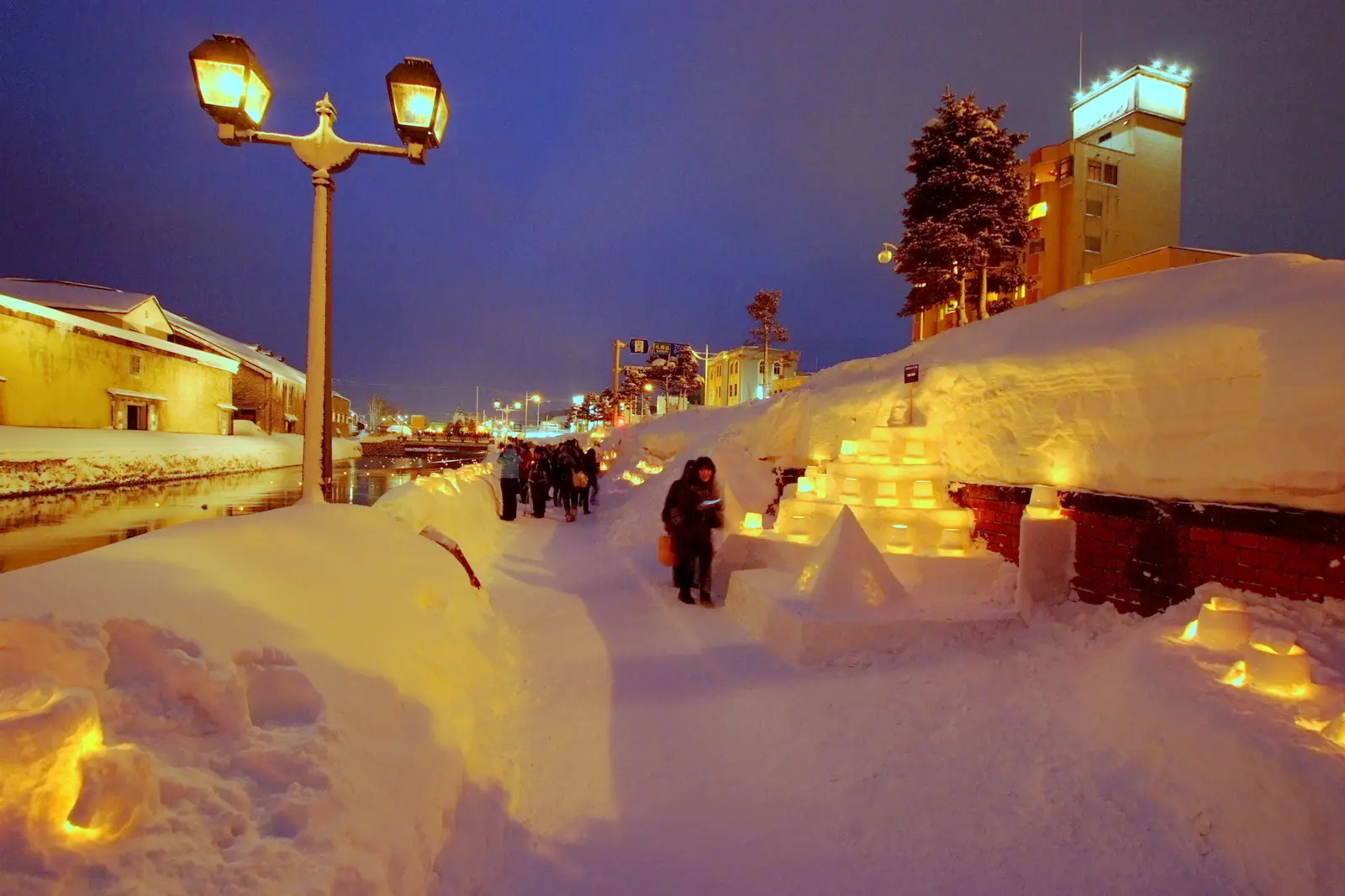 Candles along a snowy path during the Otaru Snow Light Path.